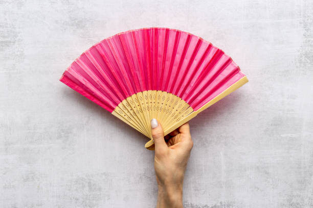 istock Hand holding hand fan made of bamboo and paper 1314964721
