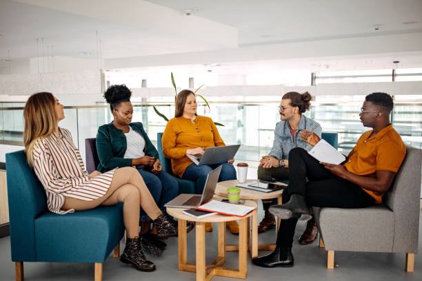 istock Group of businesspeople in office cafeteria taking a break 1314967231