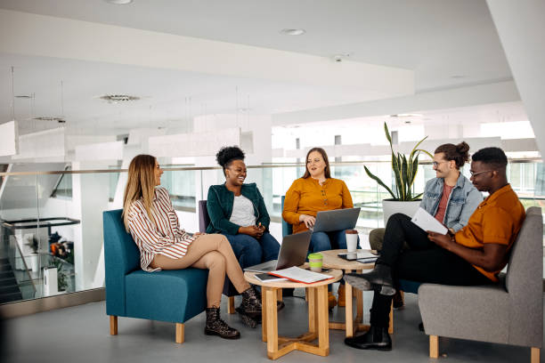 istock Group of businesspeople in office cafeteria taking a break 1314967321