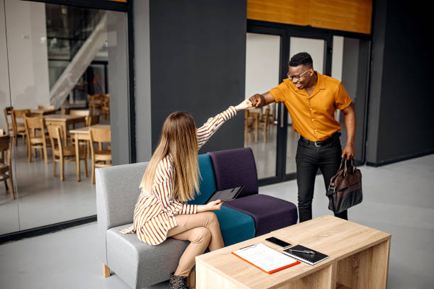 istock Young colleagues greeting in office cafeteria 1314967905