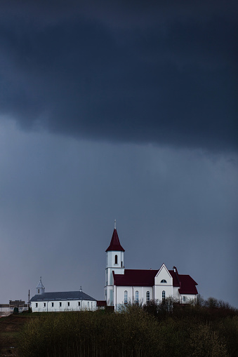 church on the background of a gloomy sky before a thunderstorm. Faith and religion