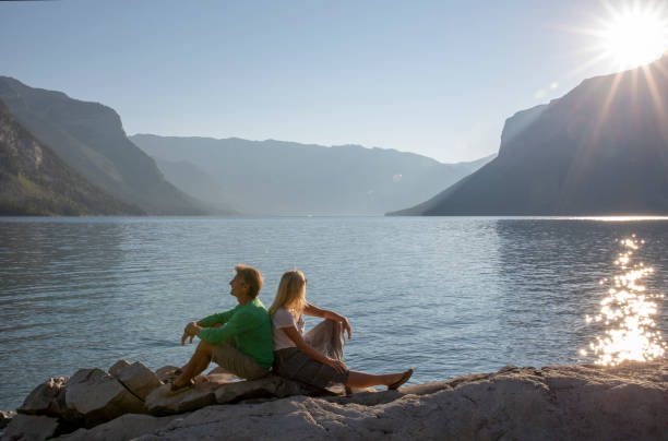 istock Mature couple relax on mountain lake shore 1314971433