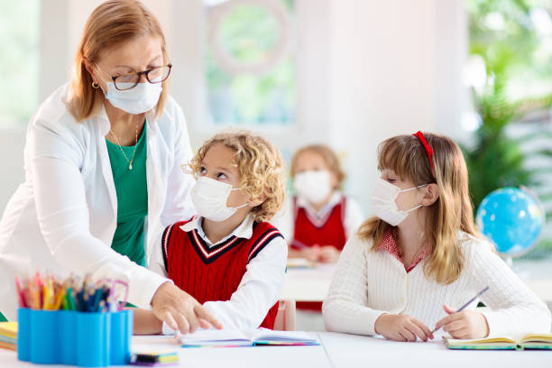 istock Kids in face mask. Child in school. 1314972427