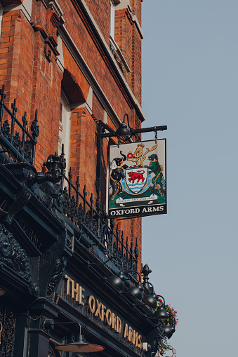 London, UK - August 12, 2020: Sign and emblem on the facade of The Oxford Arms pub on empty High Street in Camden Town, London, an area famed for its market and nightlife and popular with tourists.