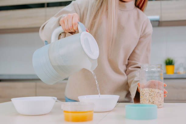 istock Mom prepares oatmeal with honey in the kitchen. 1314974209