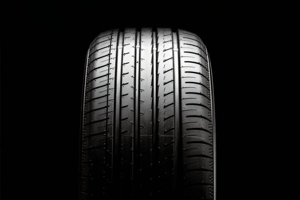 istock summer car tire tread, front view, black background 1314975167