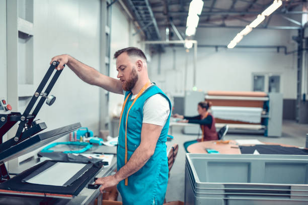istock Bearded Male Textile Worker Testing New Printing Press Machine In Factory 1314976096
