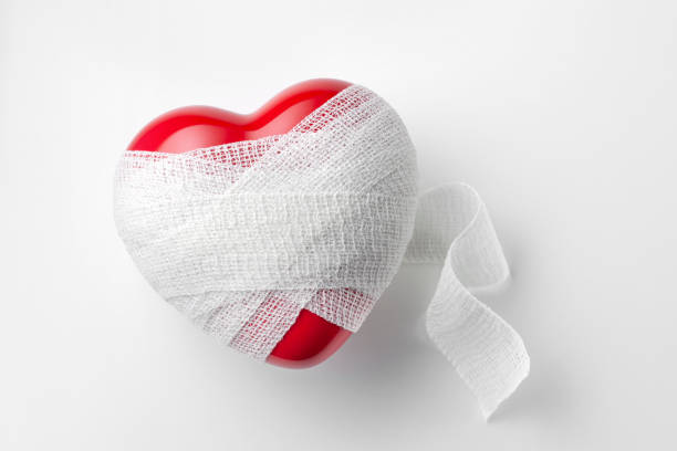 Wounded heart Banded heart isolated on a white background. bandage photos stock pictures, royalty-free photos & images