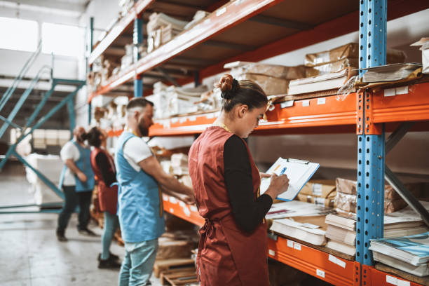 istock Textile Factory Workers Writing Down Cargo Information In Warehouse 1314976948