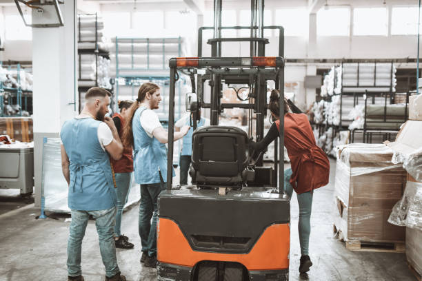 istock Warehouse Workers Trying To Fix Forklift In Warehouse 1314977563