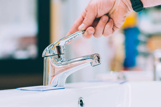 istock A man in a hardware store selects a faucet for the sink and washbasin. 1314978260