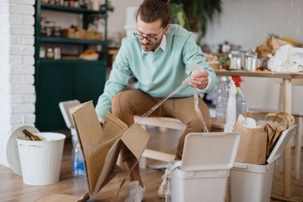istock Young man separates plastic tape from cardboard. Recycling 1314979220