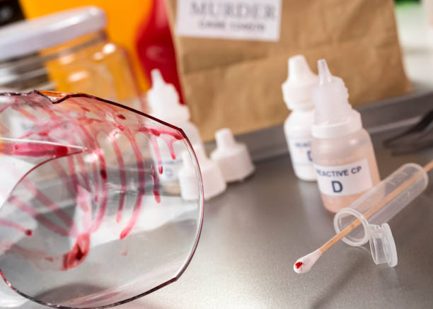 istock Police expert gets blood sample from a broken glass bottle in Criminalistic Lab, conceptual image 1314980188