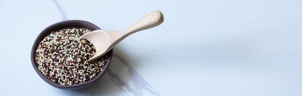 istock Tricolor quinoa scoop in brown ceramic bowl copy space 1314981295