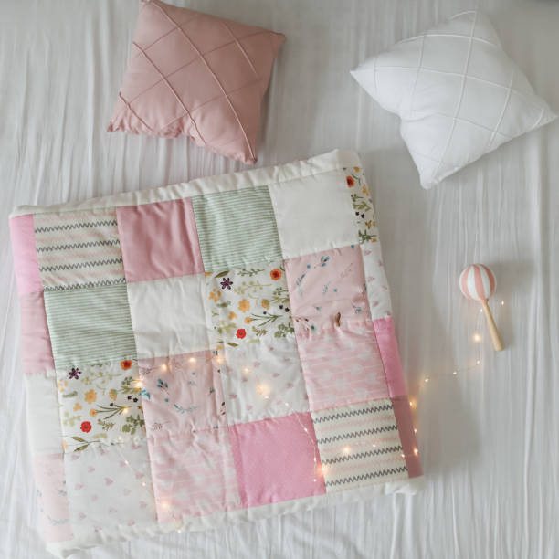 istock Cozy baby cot with a patchwork blanket. Baby bedding and textile for nursery 1314981366