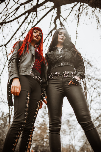Gothic Females Standing Under Tree In Park