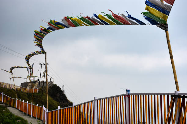 istock Yellow and white iron fencing with flying prayer flags 1314982636