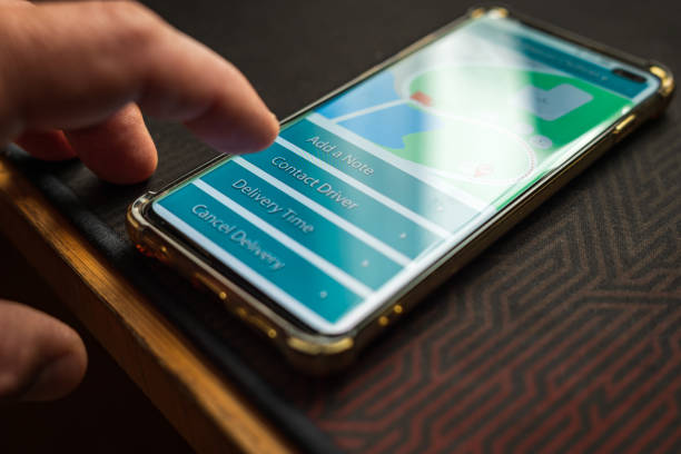 istock Male thumb finger over parcel delivery app on smartphone screen 1314982814