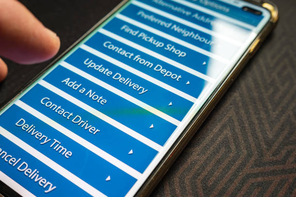Male thumb finger over parcel delivery app on smartphone screen