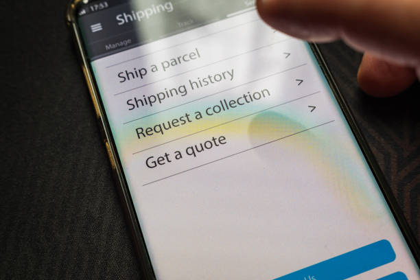 istock Male thumb finger over parcel delivery app on smartphone screen 1314982837