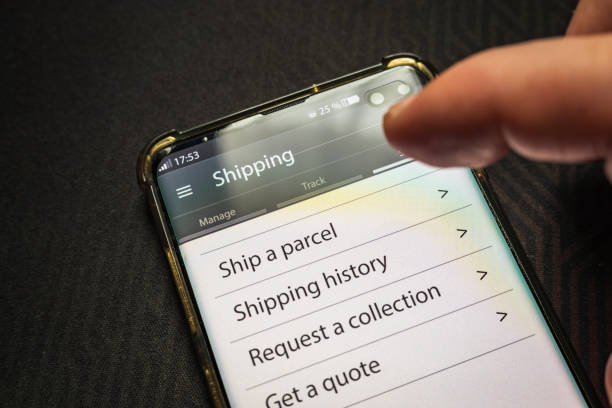 istock Male thumb finger over parcel delivery app on smartphone screen 1314982840