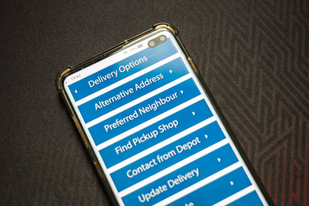 istock Male thumb finger over parcel delivery app on smartphone screen 1314982862