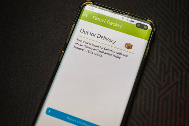 istock Male thumb finger over parcel delivery app on smartphone screen 1314982873