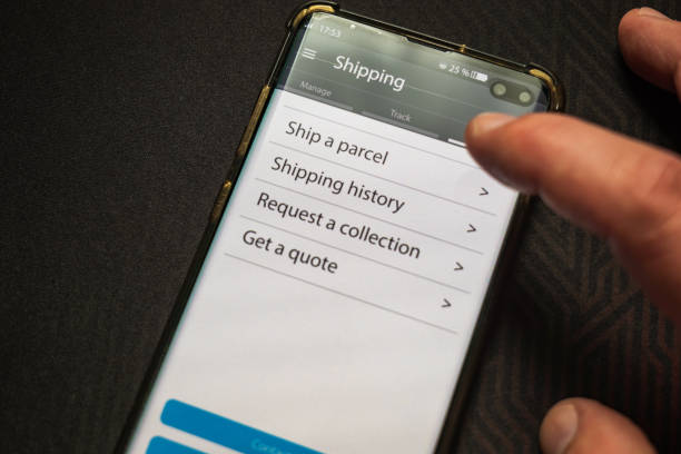istock Male thumb finger over parcel delivery app on smartphone screen 1314982888
