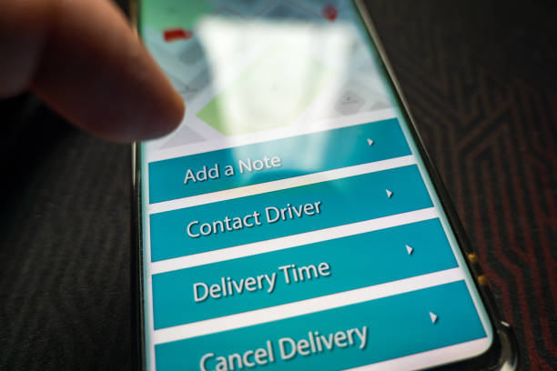 istock Male thumb finger over parcel delivery app on smartphone screen 1314982896
