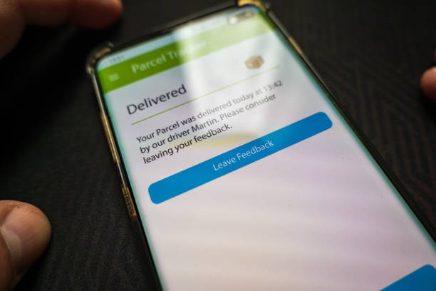 istock Male thumb finger over parcel delivery app on smartphone screen 1314982912
