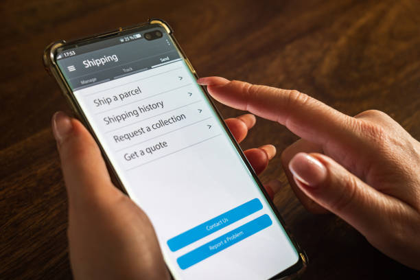 istock Male thumb finger over parcel delivery app on smartphone screen 1314982938