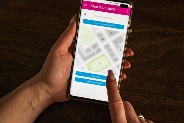istock Male thumb finger over parcel delivery app on smartphone screen 1314982947