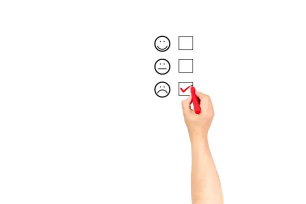 Photo of Man hand putting check mark with red marker on poor customer service evaluation form