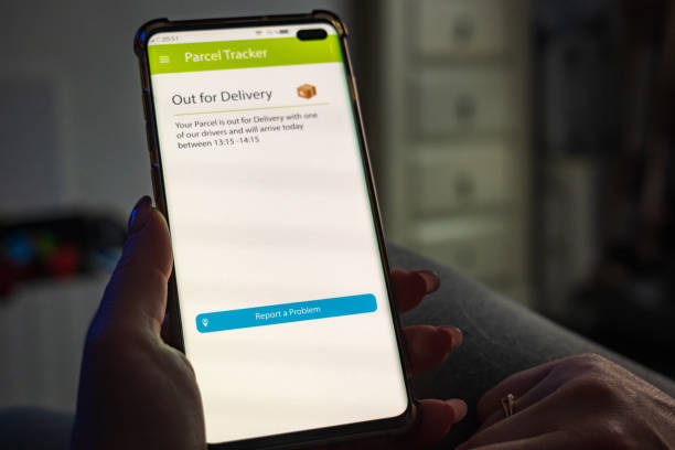 istock Male thumb finger over parcel delivery app on smartphone screen 1314983028