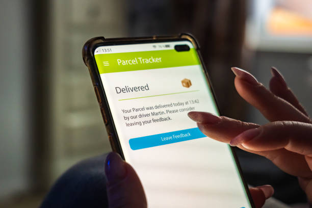istock Male thumb finger over parcel delivery app on smartphone screen 1314983037