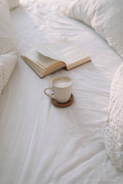 istock Open book on bedsheets and a cup of coffee. Good morning. Breakfast in bed. flat lay 1314983192