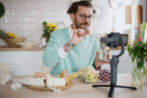 istock Young man talking about sustainable and reusable straws in zero waste vlog 1314984199