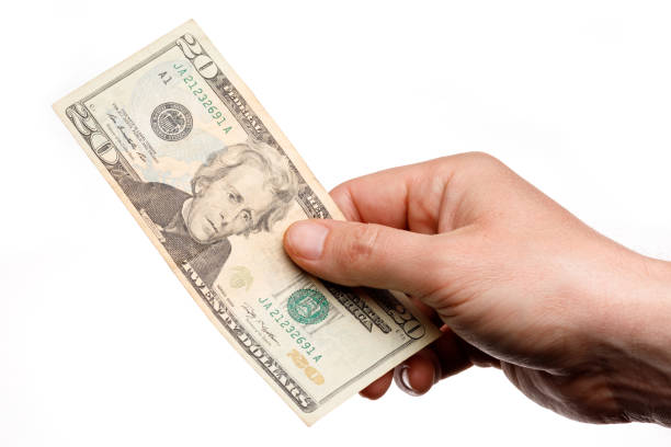istock Money 20 dollars banknote in hands on a white background 1314984785