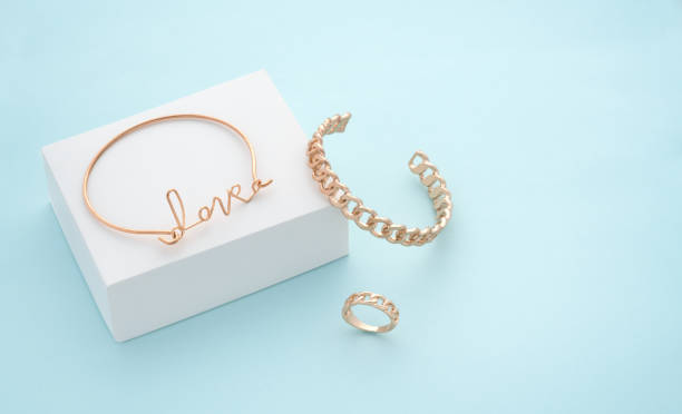 istock Love word shape bracelet on white box on blue background with copy space 1314987157