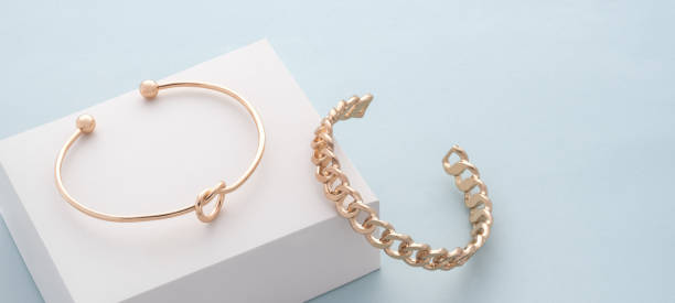 istock knot shape and chain shape bracelets on white box on blue background with copy space 1314987161