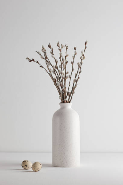 istock Easter eggs and a bouquet of willow trees in a vase on a white background 1314988542