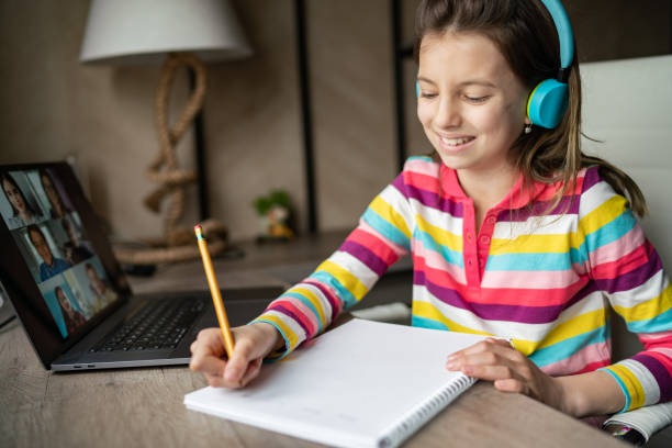 istock Child whit headphones doing her homework at home 1314989739