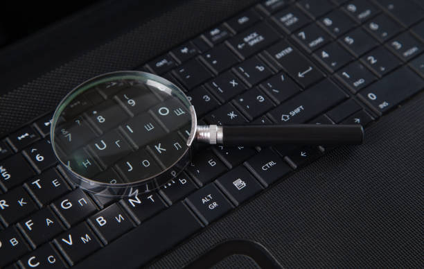 istock Magnifying glass is located on the keyboard. Black color computer and magnifying glass. 1314990202