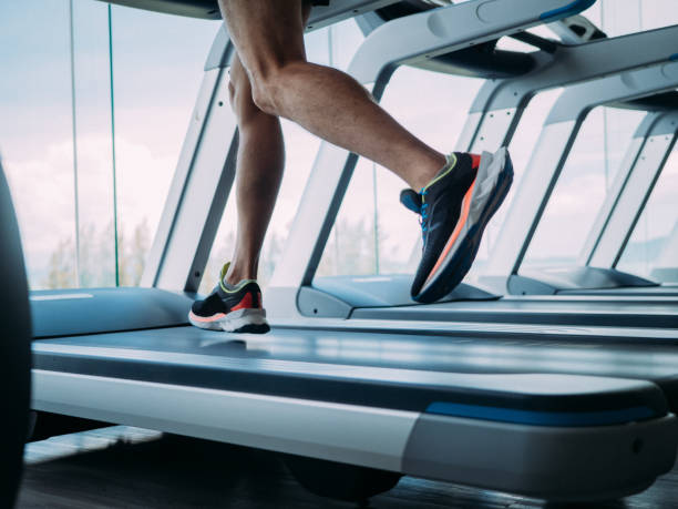 Asian man running on treadmill. Asian man running on treadmill at gym on weekend. sportsman professional sport side view horizontal stock pictures, royalty-free photos & images