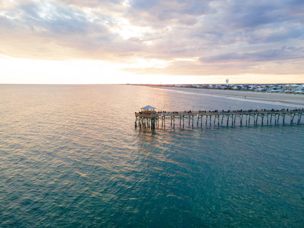 Drone View of Oceanana Pier in Atlantic Beach, North Carolina at Sunset Aerial view of the Oceanana Pier in Atlantic Beach on the Crystal Coast of North Carolina at sunset. outer banks north carolina stock pictures, royalty-free photos & images