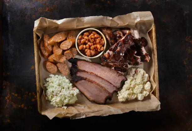 Dry Rubbed Beef Brisket with Pork Ribs, Chorizo Sausage, Baked Beans, Creamy Coleslaw and Potato Salad