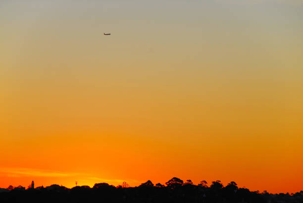 A plane departs from Sydney Kingsford Smith Airport on a beautiful summer evening in Australia.