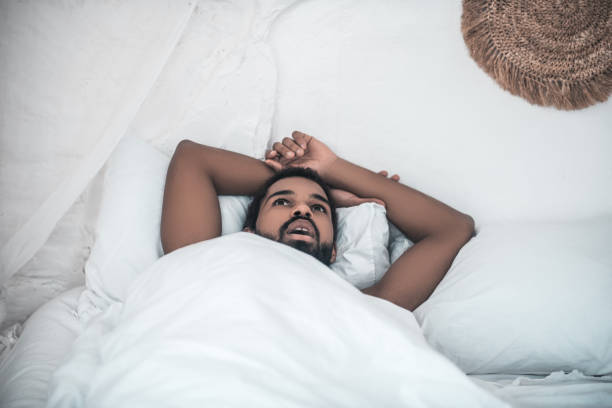 istock African american lying calmly thinking in bed 1314994432