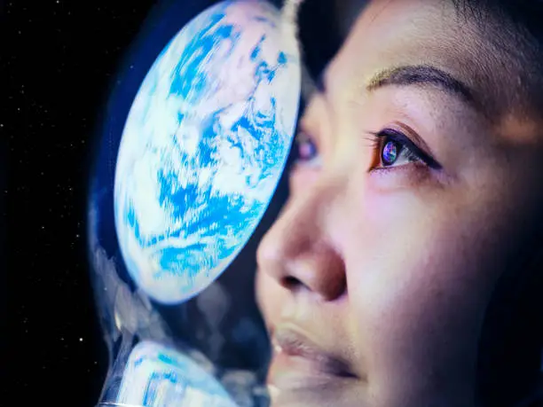 Photo of Woman in Space with Earth Reflection
