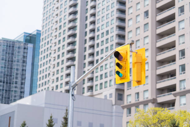 yellow traffic light on a suuny day in canada - walking point of view imagens e fotografias de stock